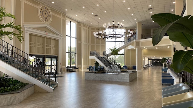 432 Grantham Unit B, Deerfield Beach, FL 33442 - common area featuring a decorative wall, a towering ceiling, stairway, and recessed lighting