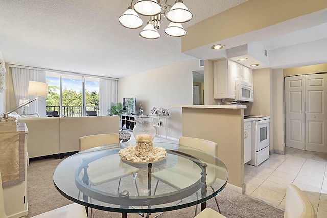2121 N Ocean Blvd Unit 404W, Boca Raton, FL 33431 - dining room with a textured ceiling, a notable chandelier, light carpet, and baseboards