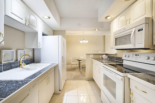 2121 N Ocean Blvd Unit 404W, Boca Raton, FL 33431 - kitchen with white appliances, white cabinets, a chandelier, a sink, and light tile patterned floors