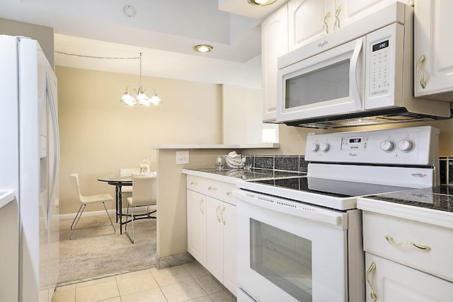 2121 N Ocean Blvd Unit 404W, Boca Raton, FL 33431 - kitchen with an inviting chandelier, light carpet, white appliances, white cabinetry, and light tile patterned floors