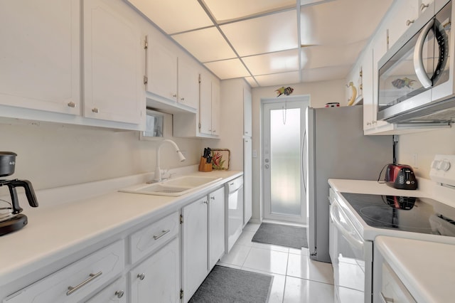3101 S Ocean Blvd Unit 220, Highland Beach, FL 33487 - kitchen with white appliances, a sink, white cabinets, light tile patterned floors, and light countertops