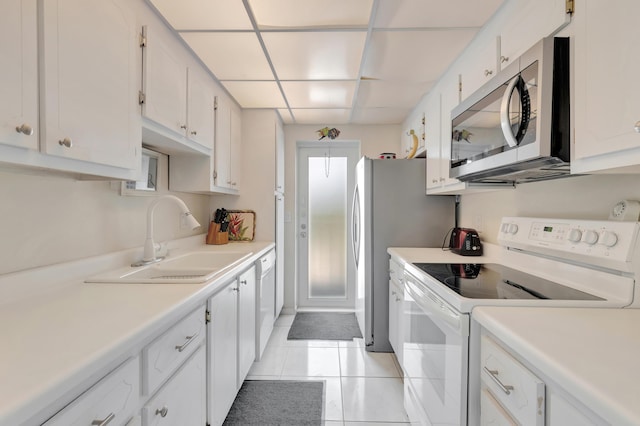 3101 S Ocean Blvd Unit 220, Highland Beach, FL 33487 - kitchen featuring white appliances, a sink, white cabinets, light countertops, and light tile patterned floors