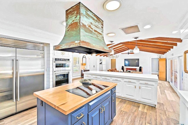 940 Turner Quay, Jupiter, FL 33458 - kitchen featuring island range hood, a center island, stainless steel appliances, wood counters, and blue cabinetry