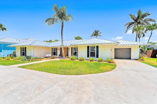 940 Turner Quay, Jupiter, FL 33458 - ranch-style house with a front lawn, a garage, a standing seam roof, driveway, and metal roof