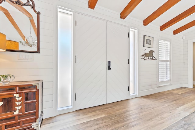 940 Turner Quay, Jupiter, FL 33458 - entryway featuring wooden walls, vaulted ceiling with beams, a chandelier, and wood finished floors