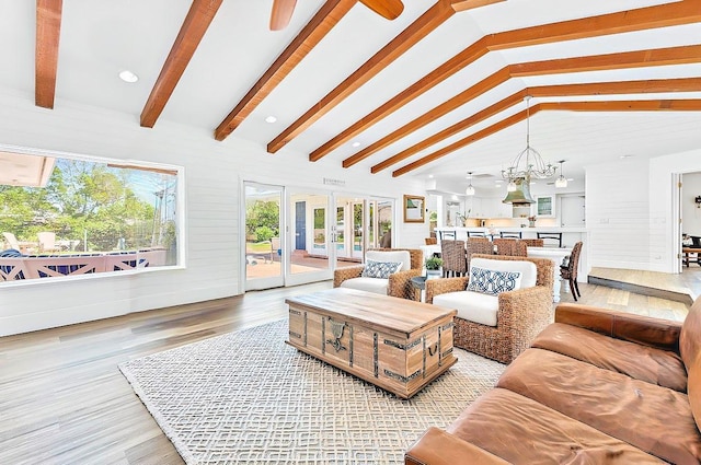 940 Turner Quay, Jupiter, FL 33458 - living room featuring vaulted ceiling with beams, light wood finished floors, and ceiling fan with notable chandelier