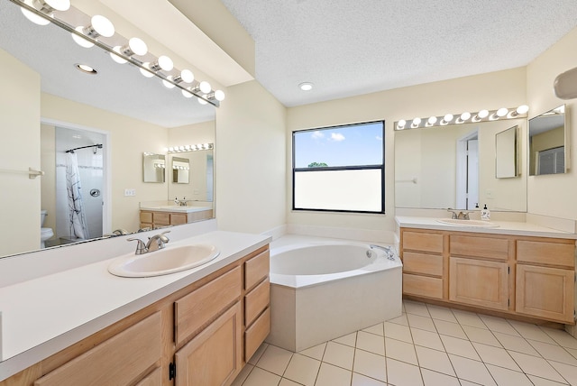 6089 Adams St, Jupiter, FL 33458 - bathroom featuring tile patterned flooring, a garden tub, two vanities, and a sink