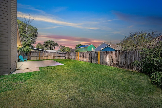 6089 Adams St, Jupiter, FL 33458 - yard at dusk with a patio and a fenced backyard