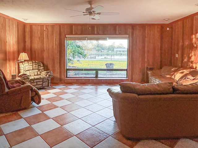 living room with ceiling fan and wood walls