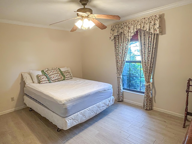 bedroom with ornamental molding, a ceiling fan, light wood-style floors, and baseboards