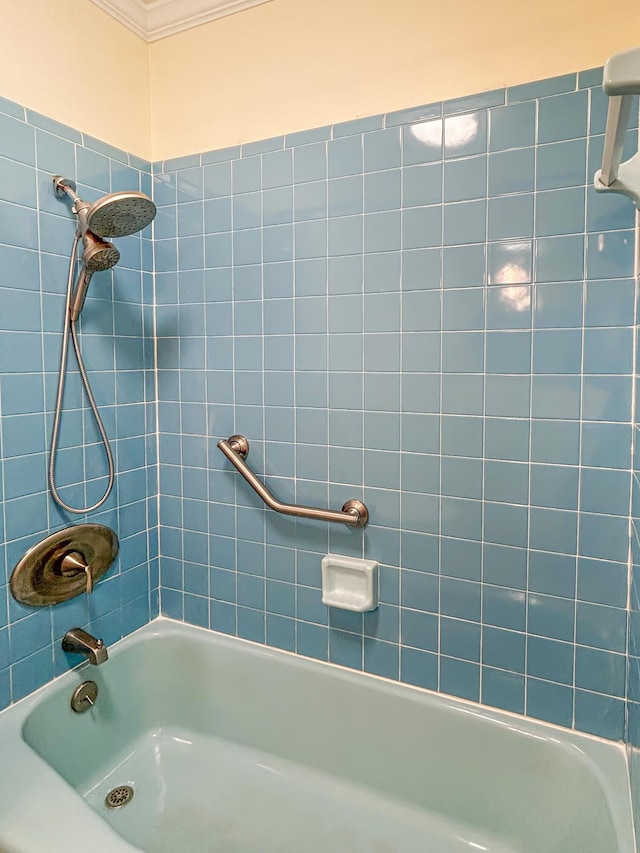 full bath with ornamental molding and shower / tub combination