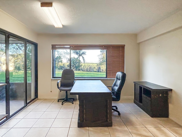 office space with baseboards and light tile patterned floors