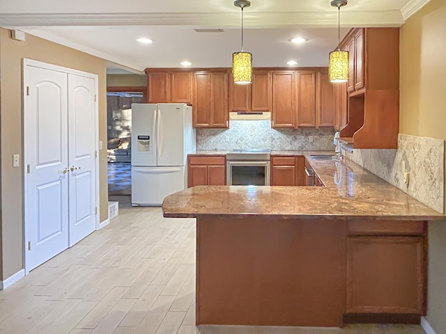 kitchen with brown cabinetry, light stone countertops, appliances with stainless steel finishes, and under cabinet range hood