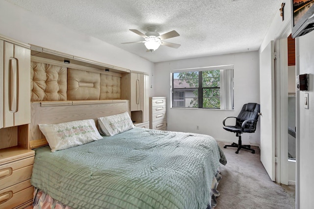 bedroom with baseboards, ceiling fan, a textured ceiling, and carpet flooring