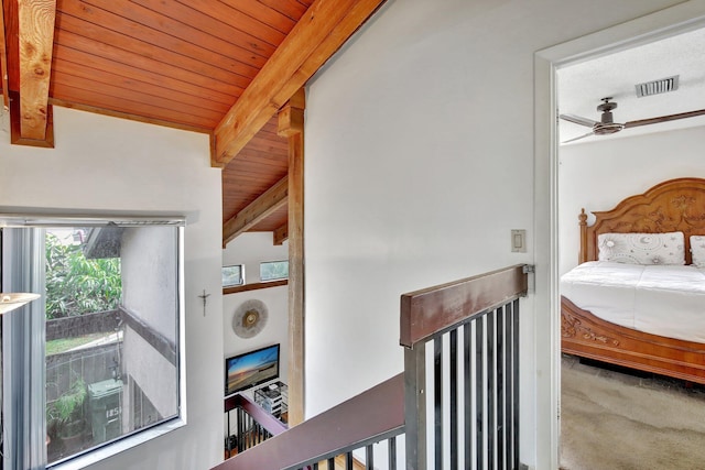 bedroom with beam ceiling, carpet, visible vents, and wood ceiling