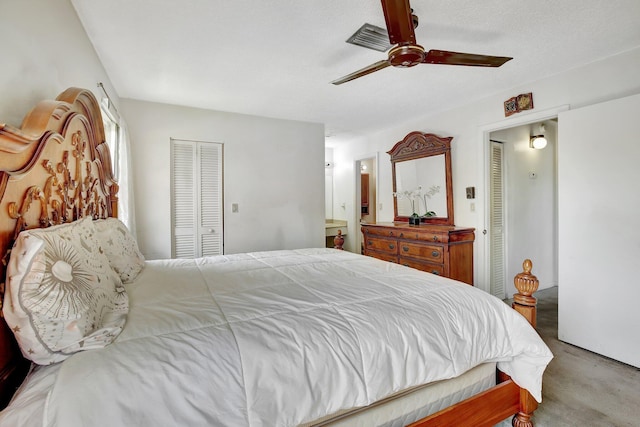carpeted bedroom with ceiling fan, connected bathroom, and a closet