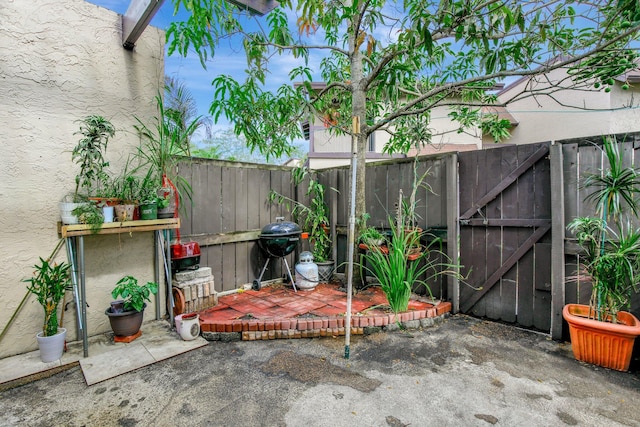 view of patio / terrace with a gate, fence, and area for grilling
