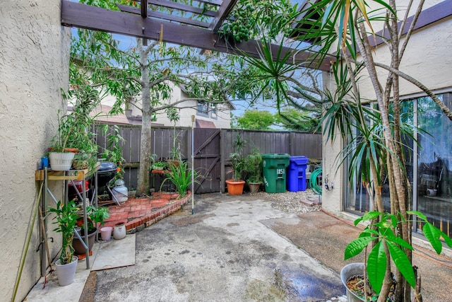 view of patio featuring a gate, a pergola, and a fenced backyard