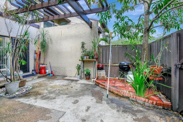view of patio featuring a fenced backyard and a pergola