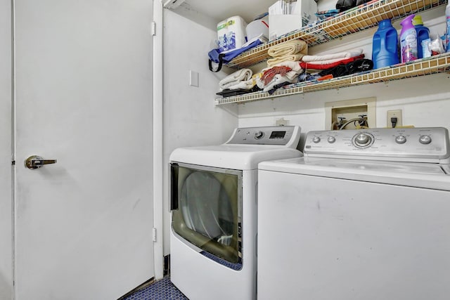 clothes washing area with washing machine and clothes dryer and laundry area