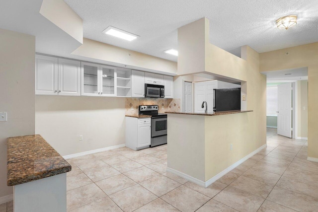 3211 Tuscany Way, Boynton Beach, FL 33435 - kitchen featuring appliances with stainless steel finishes, white cabinetry, tasteful backsplash, light tile patterned flooring, and a textured ceiling