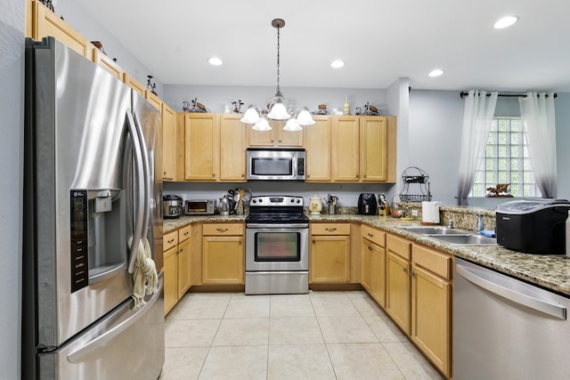 1023 Center Stone Ln, Riviera Beach, FL 33404 - kitchen with a sink, a chandelier, light brown cabinets, and stainless steel appliances
