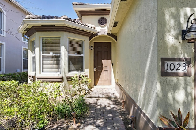 1023 Center Stone Ln, Riviera Beach, FL 33404 - entrance to property with stucco siding and a tile roof