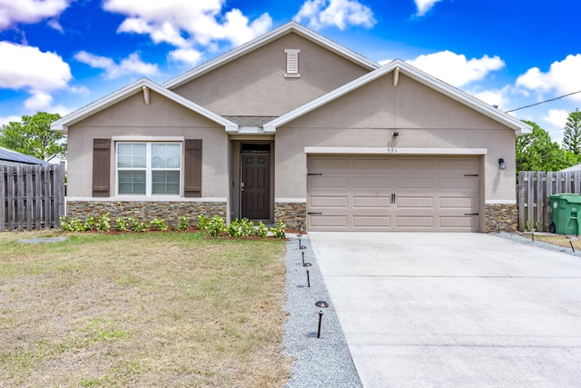 551 SW Lairo Ave, Port Saint Lucie, FL 34953 - ranch-style house with driveway, fence, stone siding, stucco siding, and a garage
