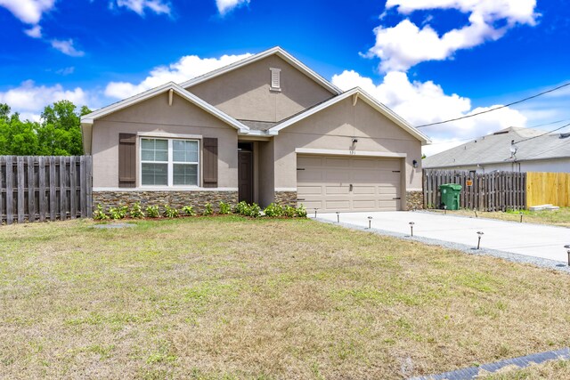 551 SW Lairo Ave, Port Saint Lucie, FL 34953 - ranch-style house featuring a garage, stucco siding, driveway, and stone siding
