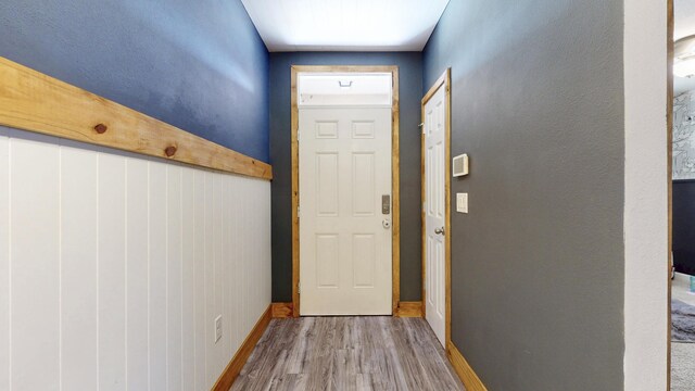 551 SW Lairo Ave, Port Saint Lucie, FL 34953 - doorway with wood finished floors and baseboards