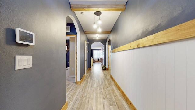 551 SW Lairo Ave, Port Saint Lucie, FL 34953 - corridor with arched walkways, beamed ceiling, wood finished floors, and a textured wall