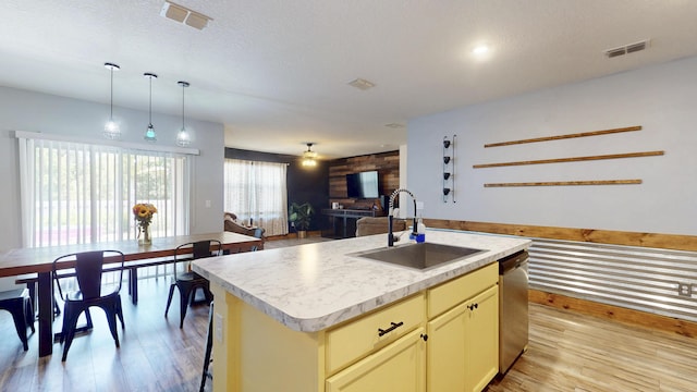 551 SW Lairo Ave, Port Saint Lucie, FL 34953 - kitchen with a sink, cream cabinetry, visible vents, light countertops, and open floor plan