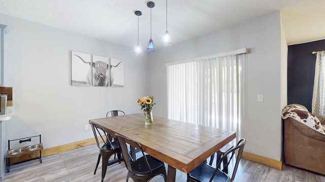 551 SW Lairo Ave, Port Saint Lucie, FL 34953 - dining area with light wood finished floors and baseboards