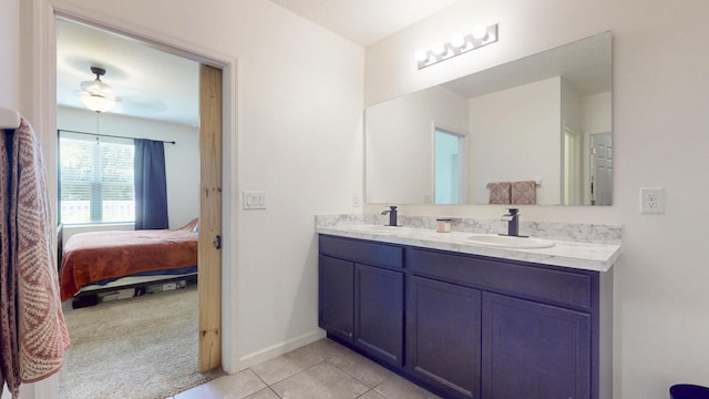 551 SW Lairo Ave, Port Saint Lucie, FL 34953 - bathroom featuring double vanity, ensuite bathroom, tile patterned flooring, and a sink