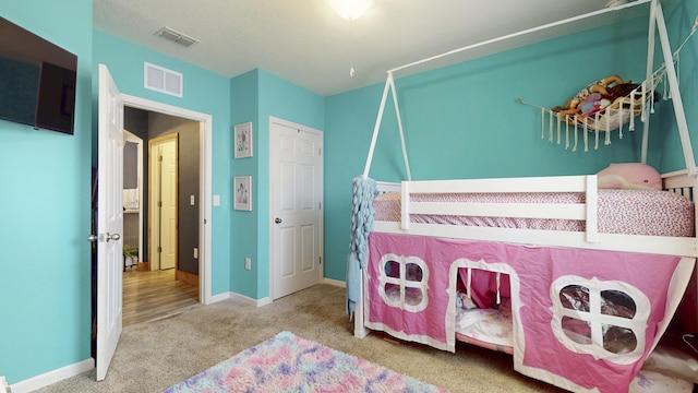 551 SW Lairo Ave, Port Saint Lucie, FL 34953 - bedroom with baseboards, visible vents, and carpet flooring