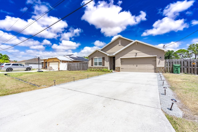 551 SW Lairo Ave, Port Saint Lucie, FL 34953 - single story home with a front lawn, stone siding, concrete driveway, and fence