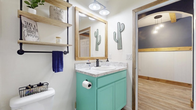 551 SW Lairo Ave, Port Saint Lucie, FL 34953 - bathroom with baseboards, wood finished floors, toilet, and vanity