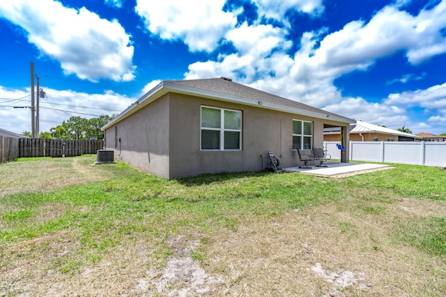 551 SW Lairo Ave, Port Saint Lucie, FL 34953 - back of property featuring a fenced backyard, stucco siding, a yard, and a patio area