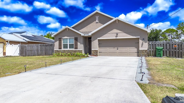 551 SW Lairo Ave, Port Saint Lucie, FL 34953 - ranch-style home featuring stucco siding, concrete driveway, an attached garage, and stone siding