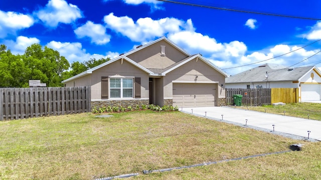 551 SW Lairo Ave, Port Saint Lucie, FL 34953 - view of front of home featuring stucco siding, driveway, stone siding, an attached garage, and fence