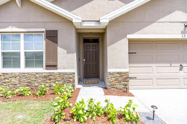 551 SW Lairo Ave, Port Saint Lucie, FL 34953 - view of exterior entry featuring stone siding and stucco siding