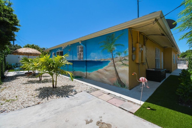 951 Green St, West Palm Beach, FL 33405 - view of property exterior with a patio and stucco siding