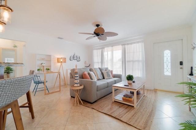951 Green St, West Palm Beach, FL 33405 - living area featuring light tile patterned floors, crown molding, ceiling fan, and baseboards