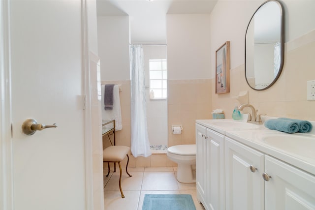 951 Green St, West Palm Beach, FL 33405 - bathroom with toilet, tiled shower, double vanity, tile patterned floors, and tile walls