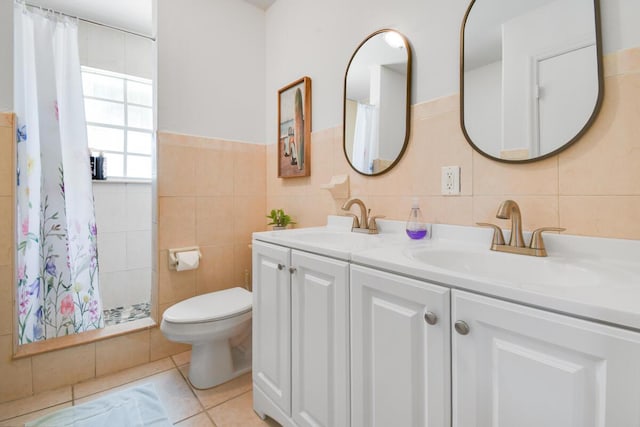 951 Green St, West Palm Beach, FL 33405 - full bath featuring tile walls, double vanity, toilet, a tile shower, and tile patterned flooring