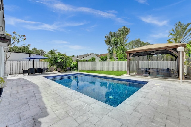 view of swimming pool with a fenced in pool, a gazebo, a fenced backyard, and a patio area
