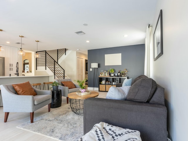 living area featuring recessed lighting, stairs, and visible vents
