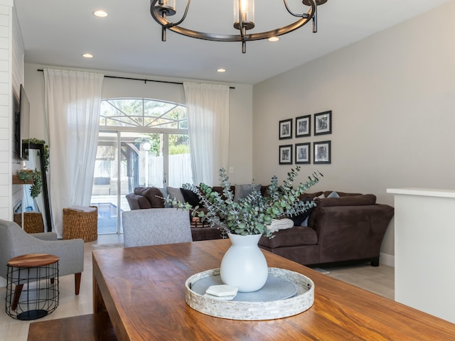 dining area featuring recessed lighting and an inviting chandelier