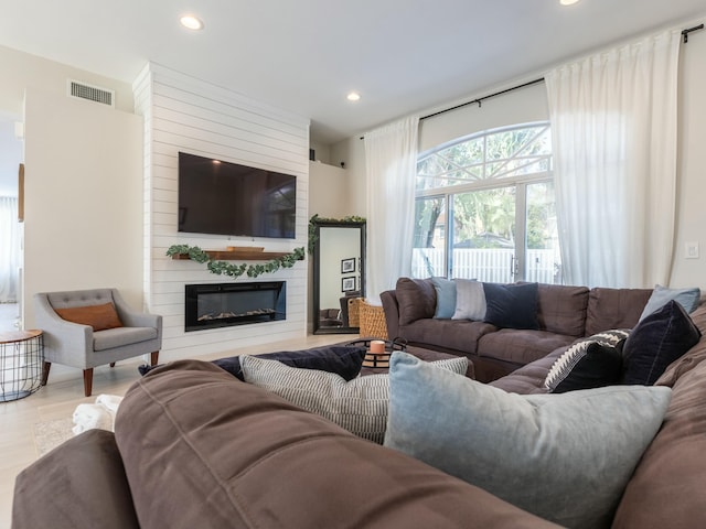 living room with visible vents, a large fireplace, and recessed lighting