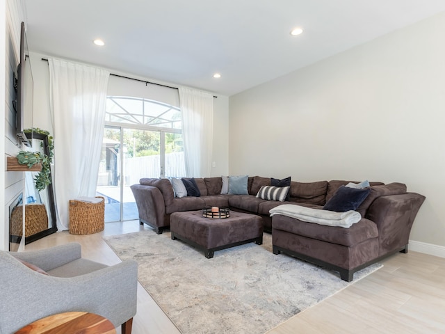 living area with recessed lighting and baseboards